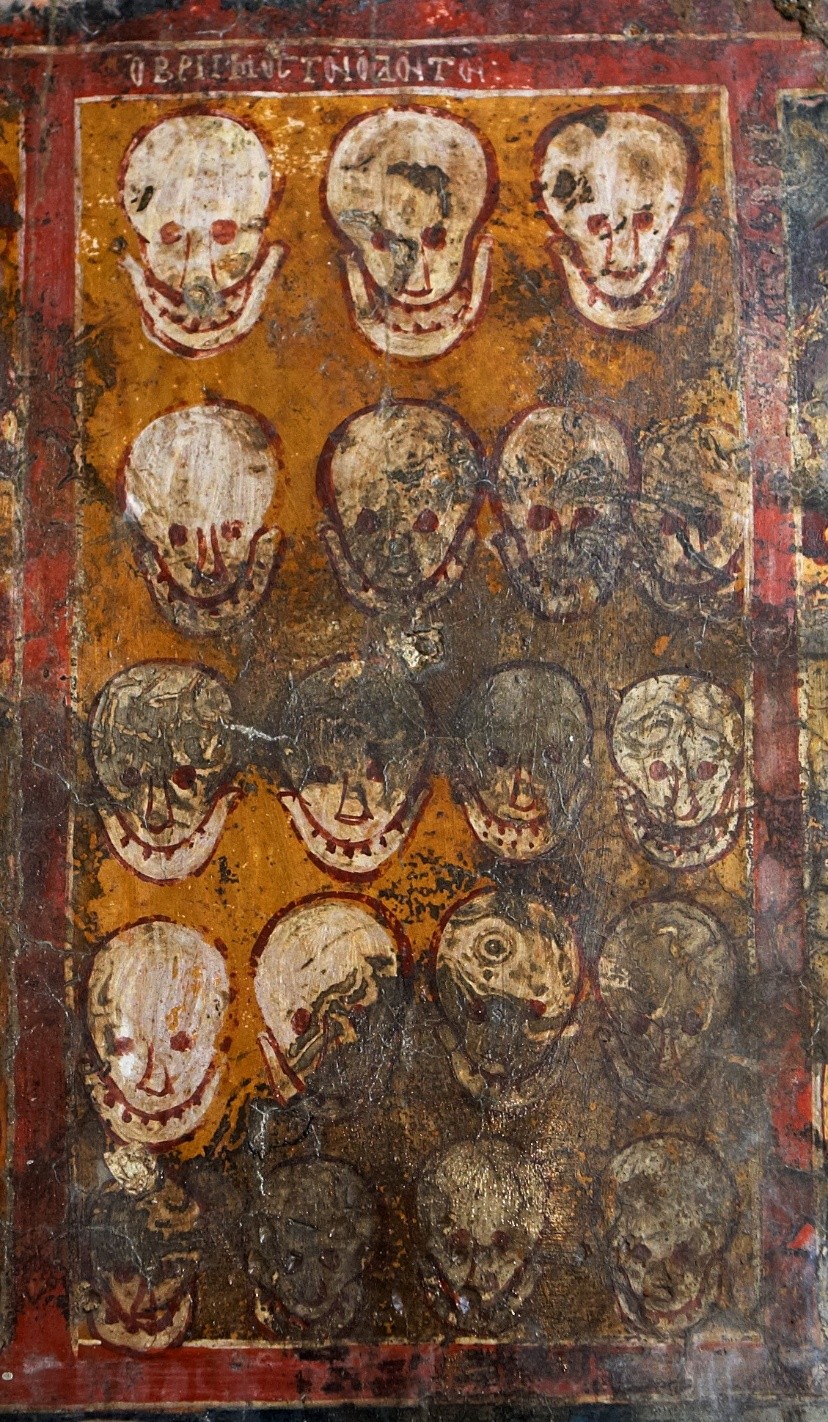 A painting of rows of skulls against a yellow and red background