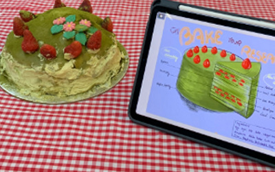 Round, green cake decorated with raspberries