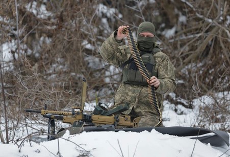 Russian soldier, wearing military uniform, sitting in the snow with a gun and bullets
