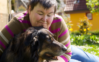Mentally disabled woman cuddling a dog