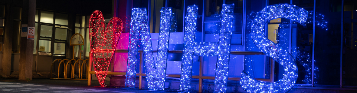 A light-up red heart and blue NHS sign