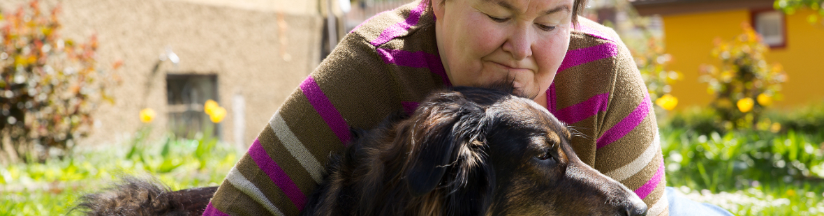 Mentally disabled woman hugging a dog