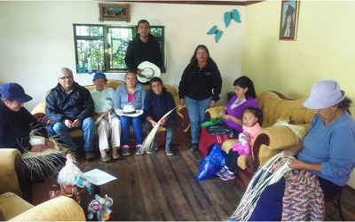 Dr Alexander Borda-Rodriguez on a recent research trip to Ecuador, surrounded by a group of workers weaving