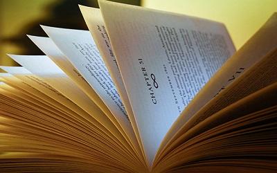 Image of an open book with the pages turning
