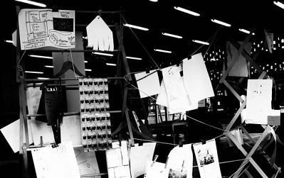 Photo of the exhibition itself, papers hanging up as described by Raktim