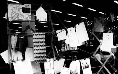 Photo of the exhibition itself, papers hanging up as described by Raktim