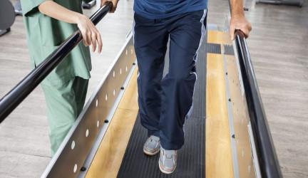 Man learning to walk on a machine