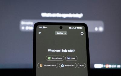 Phone screen with the question "What can I help with?" on it