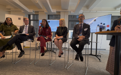 A group of men and women sitting in a row on high chairs