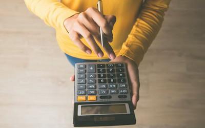Person holding a calculator