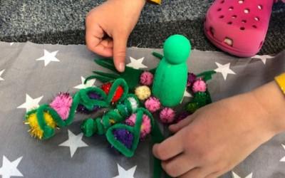 A child playing with colourful craft material