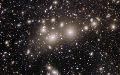 Thousands of galaxies, appearing as yellow/white lights, against a black expanse of space