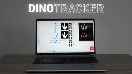 A laptop screen showing the DinoTracker app, with images of dinosaur footprints and graphs on it