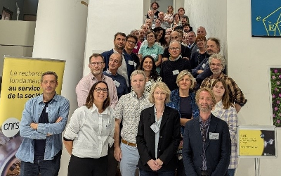 Members of the ACME consortium standing in rows on steps