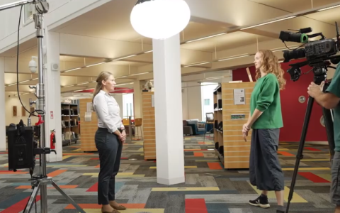 Dr. Jitka Vseteckova being interviewed in a library.