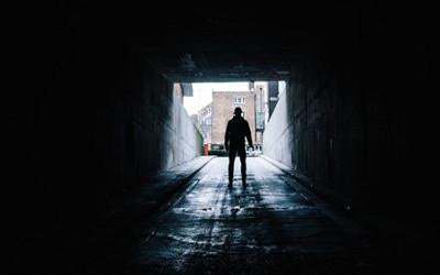 Person walking through a dark tunnel