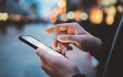 Person's hands holding a mobile phone