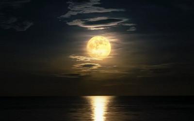 The Moon above the sea, with its reflection in the sea