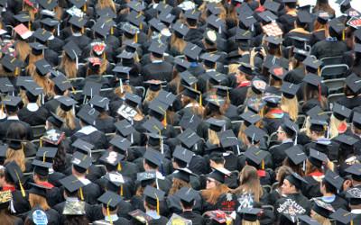 An aerial view of a group of students wearing mortarboard hats