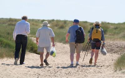 Group of people walking in sand dunes