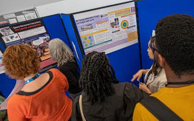 A group of people standing around looking at posters