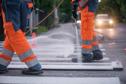 Workers painting road markings