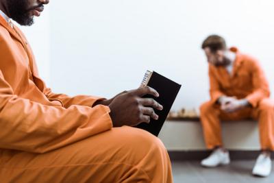 Prisoner reading a book