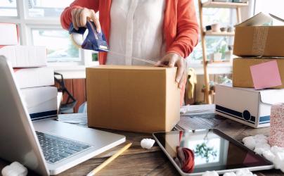 Self-employed person wrapping parcels