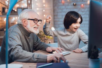 Grandfather and grandson playing computer games