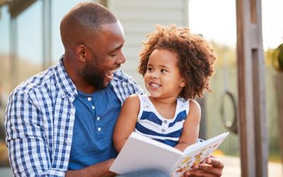 Father and daughter reading a book