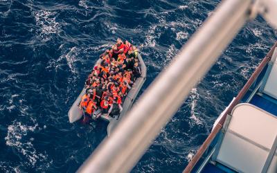 Ship rescuing migrants from dinghy