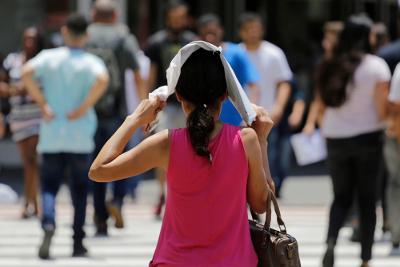 Woman protecting her head in the sun