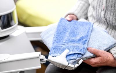 Robot handing person towels