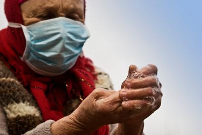 Woman wearing face mask and washing hands