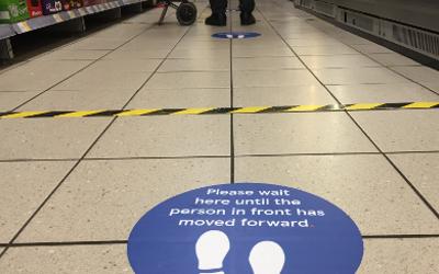 Social distancing guidelines in a supermarket