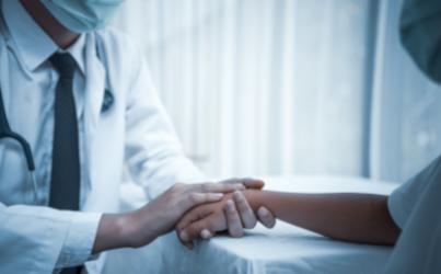 Doctor holding patient's hand