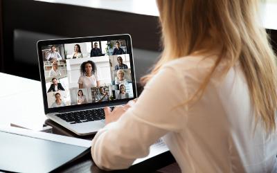 Female lady sitting at a desk looking at a laptop