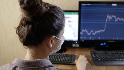 Girl wearing a mask working on a computer