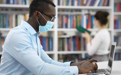Masked students in a library