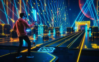 Man wearing virtual reality goggles in a virtual reality games arcade with yellow and blue lights 