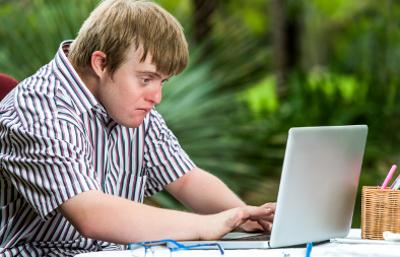 Man with Down Syndrome using a laptop