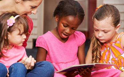 Group of children reading a book