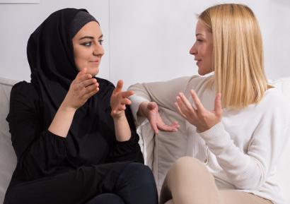 Two ladies of different ehnicity talking