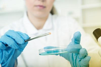 Female lab assistant with petri dish