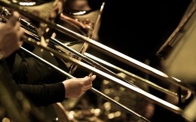 Hands on a trombone in an orchestra