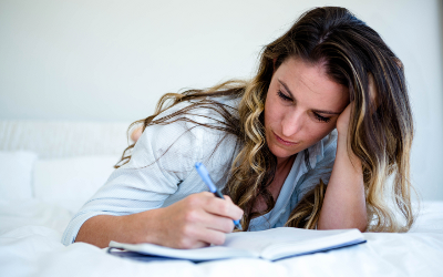 Woman writing in a book