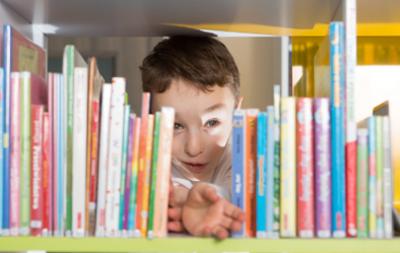 Boy looking at books