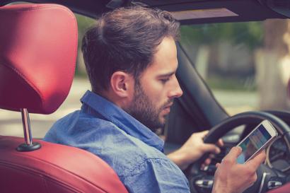 Man using mobile phone whilst driving
