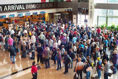 Shutterstock-575412109 People in a queue at arrival immigration
