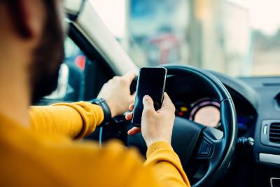 Man using mobile phone whilst driving
